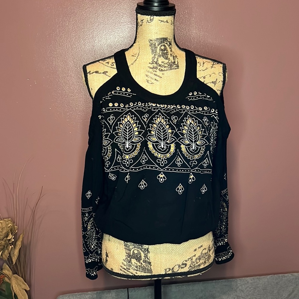 Woman’s size large black cold shoulder top.